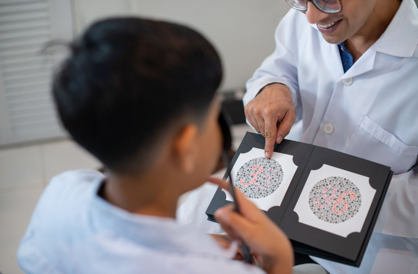 An optometrist providing a color vision test for a child.